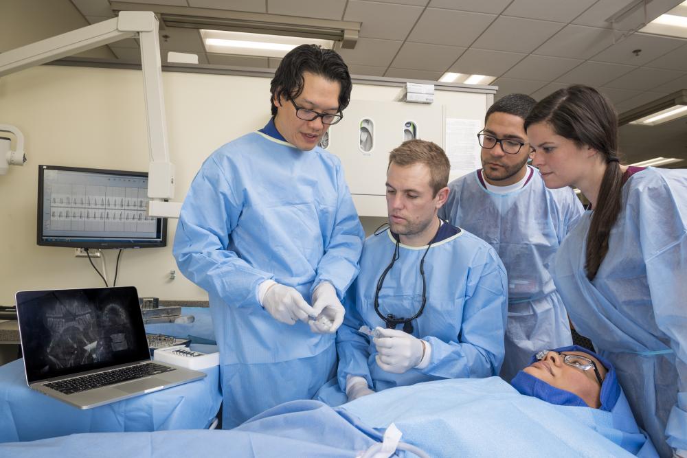 Dr. Bencharit with dental students in a simulation. Photo by Allen Jones, VCU University Marketing.
