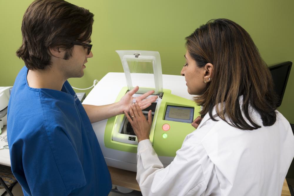 A student and instructor in Dr. Bencharit's lab.