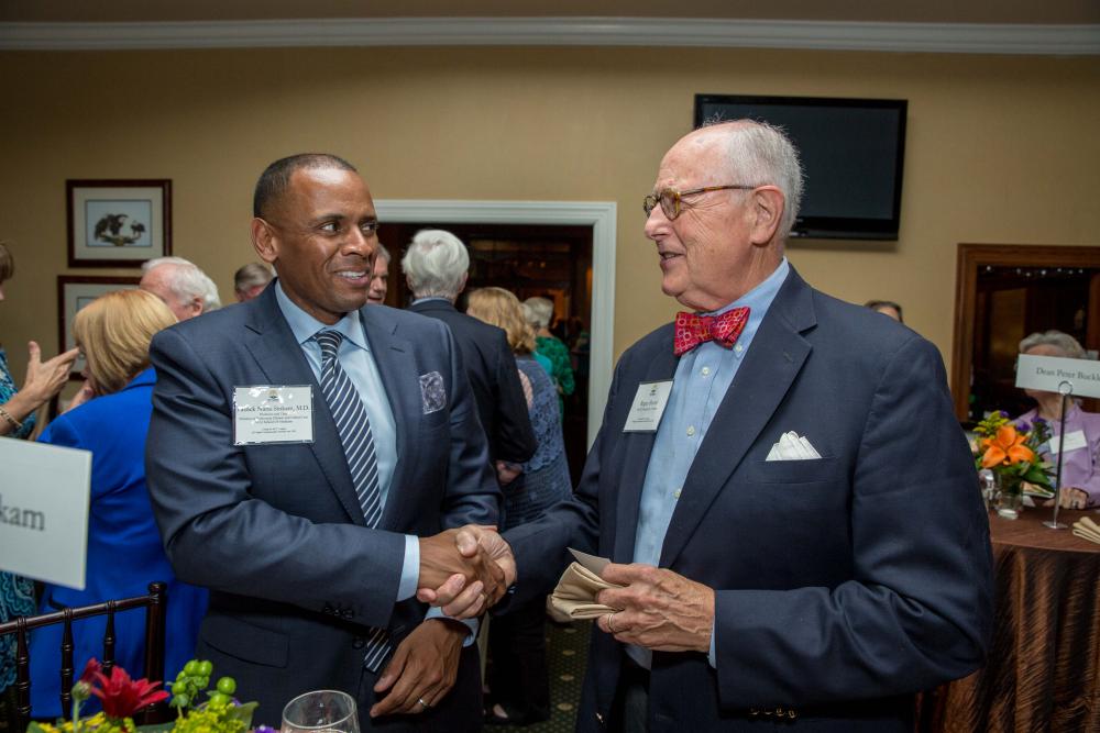 Patrick Nana-Sinkam (left), M.D., chair of the Division of Pulmonary Disease and Critical Care Medicine at VCU Health, speaks with MCV Foundation board member Roger Boevé at the Discovery Series strolling supper. 