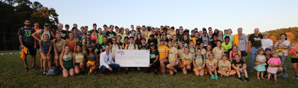 The College of William & Mary track teams, friends, family and other suporters gather with Charles and Ginny Crone at the 2017 Massey Cancer Center 5K, which was the event’s 30th year.