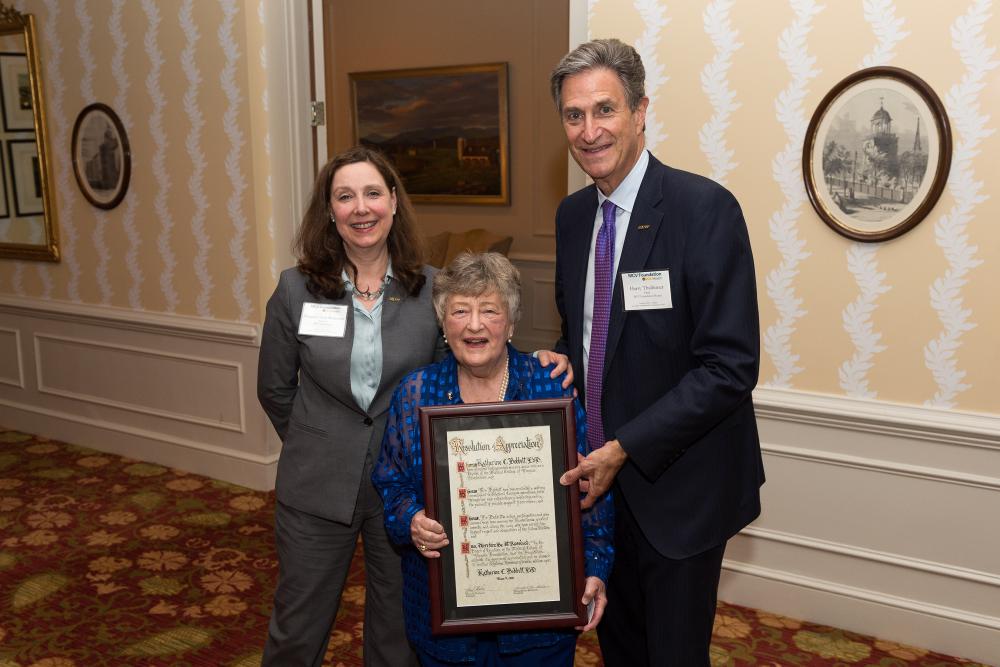 Kathy Bobbitt, Ed.D. (center), looks over her lifetime honorary trustee proclamation with Margaret Ann Bollmeier and Harry Thalhimer.