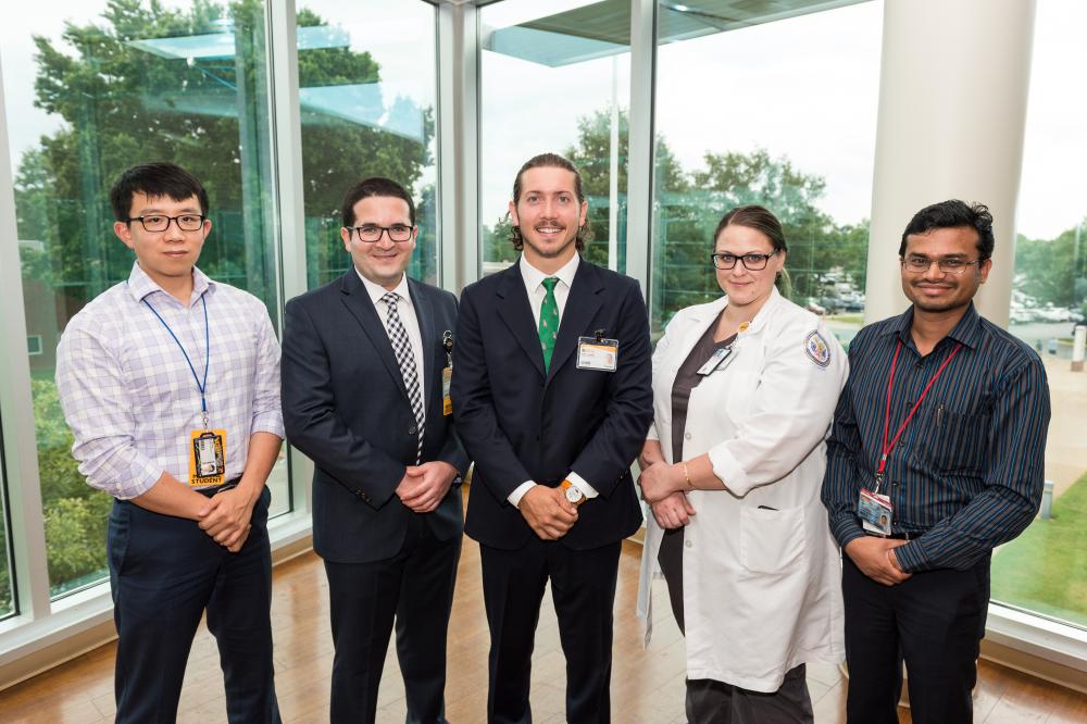 Dr. Holloway’s team includes (L to R) VCU School of Medicine students Zi Huang, Adel Azghadi and Evan Hughes, intraoperative monitoring technologist Rachel Van Aken, and post-doctoral trainee Deepak Kumbhare, Ph.D. The team is conducting research into techniques and possibilities of how deep brain stimulation can treat dementia. Photo: Kevin Schindler