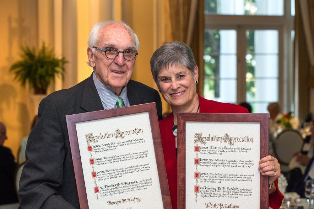 Joe Teefey, who served nine years on the MCV Foundation Board of Trustees, and Judy Collins, who served 21 years, review the resolutions welcoming them as the board’s newest Lifetime Honorary Trustees.
