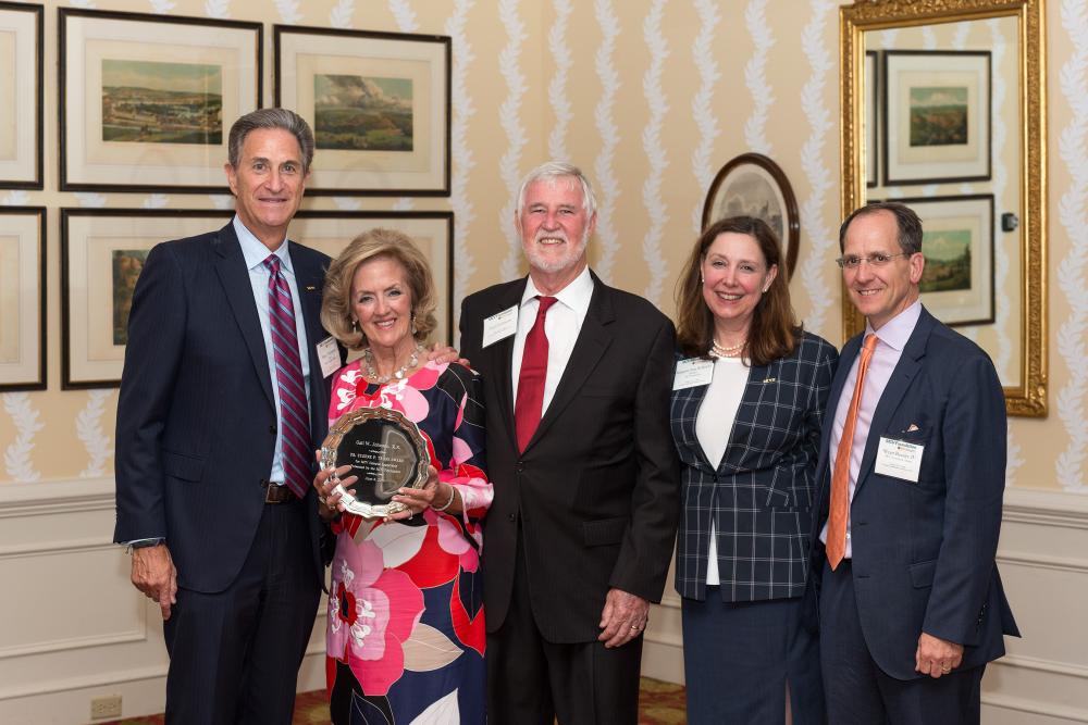 Gail Johnson, a former chair and current Lifetime Honorary Trustee of the MCV Foundation Board of Trustees, displays her Eugene P. Trani Award, which she received in recognition of her exceptional dedication and support of the MCV Campus. Harry Thalhimer, Earl Johnson, Margaret Ann Bollmeier and MCV Foundation Chair-Elect Wyatt Beazley IV congratulate her.