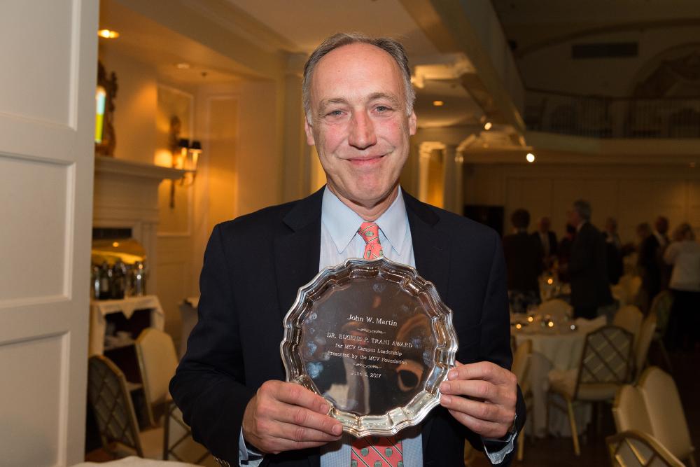 John Martin, who wasn’t able to attend this year’s annual dinner and awards ceremony, holds his Eugener P. Trani MCV Campus Leadership Award at the event in 2017.