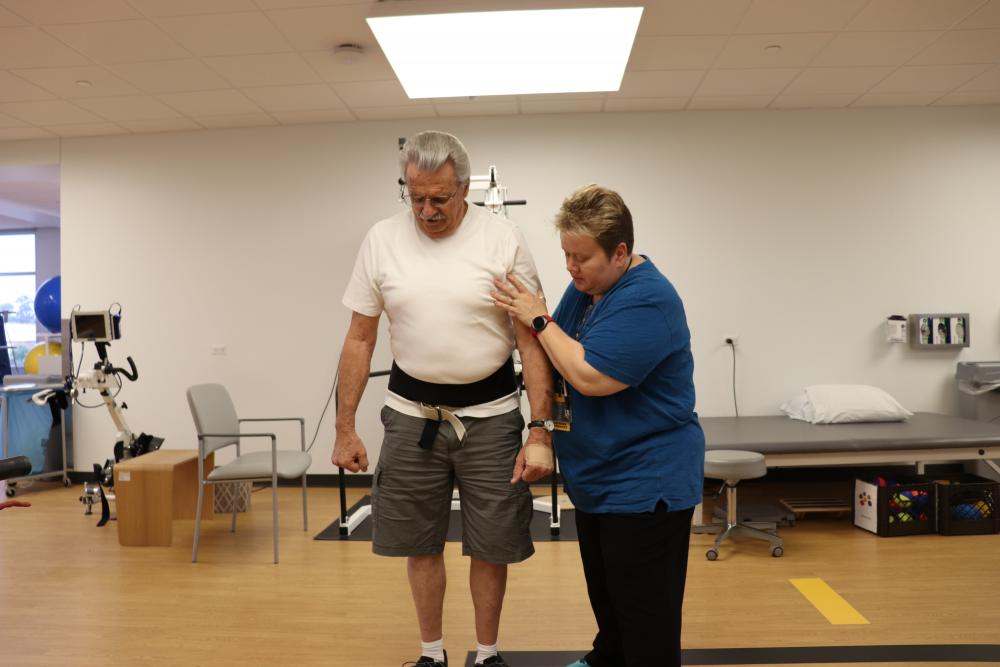 VCU Health N.O.W Center physical therapist Mary Beth O’Reilly helps patient Corbin Cash with exercises during a recent visit.
