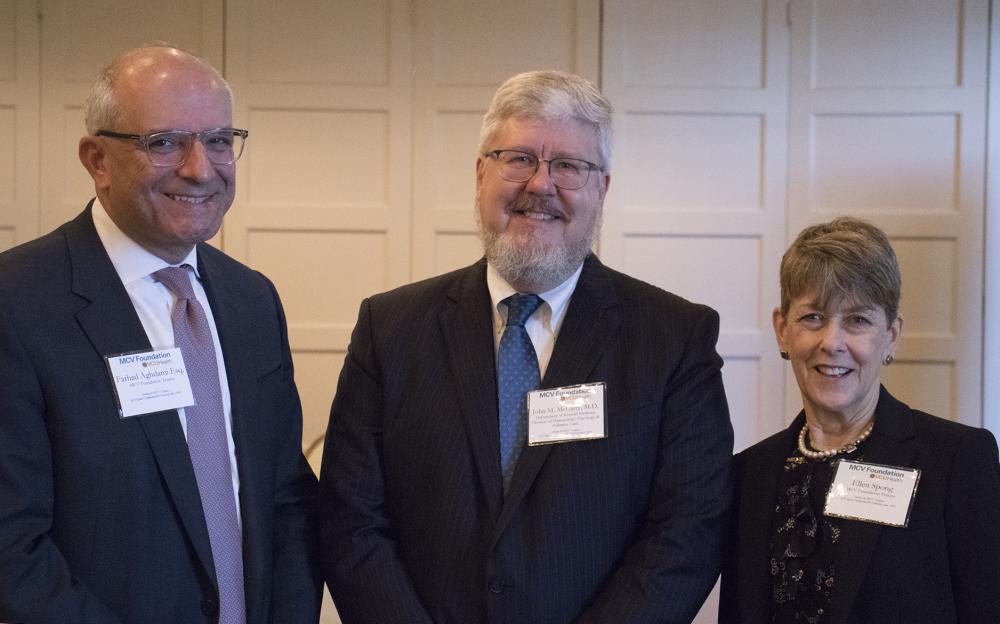 Farhad Aghdami (left) and Ellen Spong (right), both MCV Foundation board members, welcome John McCarty, M.D., to speak at a recent MCV Foundation event.