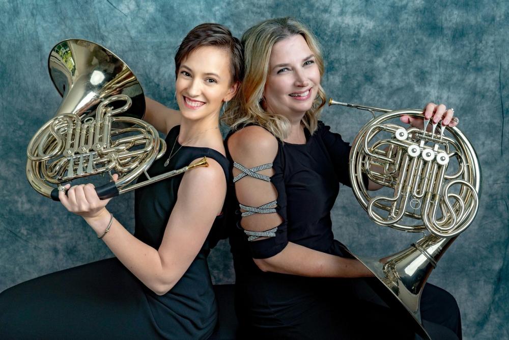 Kara Dods (left), an M.D./Ph.D. student and French hornist, poses with Theresa Erichsen, a registered nurse and fellow French hornist. Theresa is a co-founder and manager of the VCU Health System Orchestra and Kara is the librarian. Photo: Drs. Mimi Peberdy and Joe Ornato