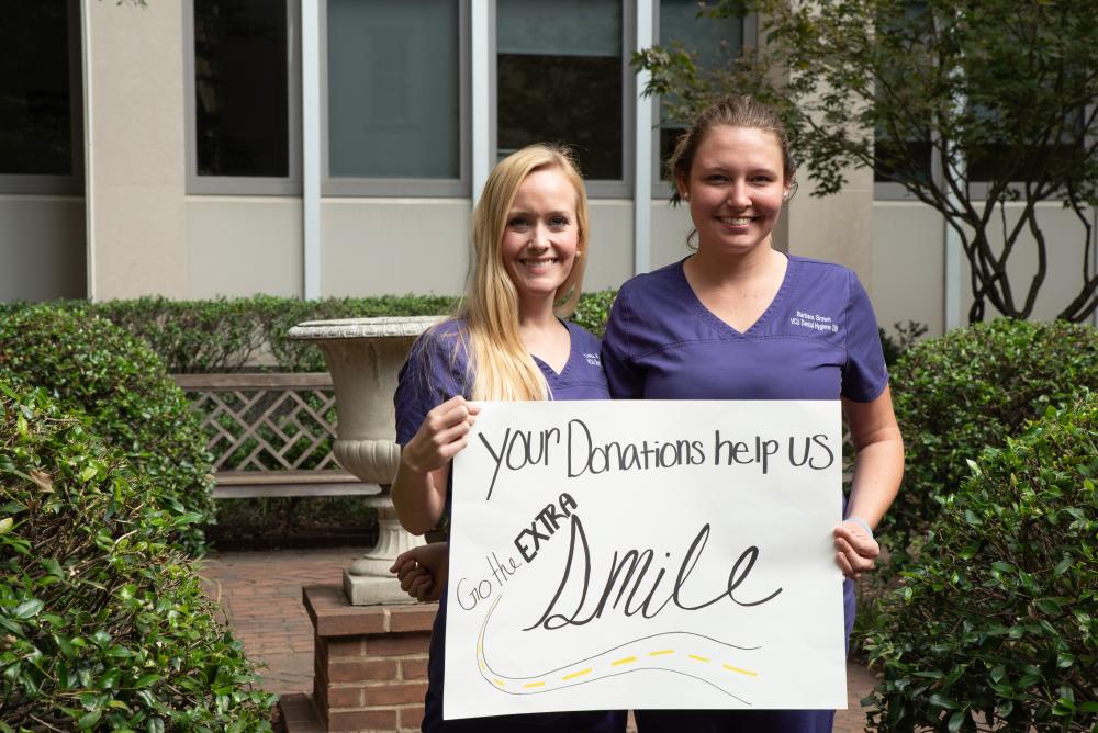 MCV Campus students with a sign thanking donors for their support.