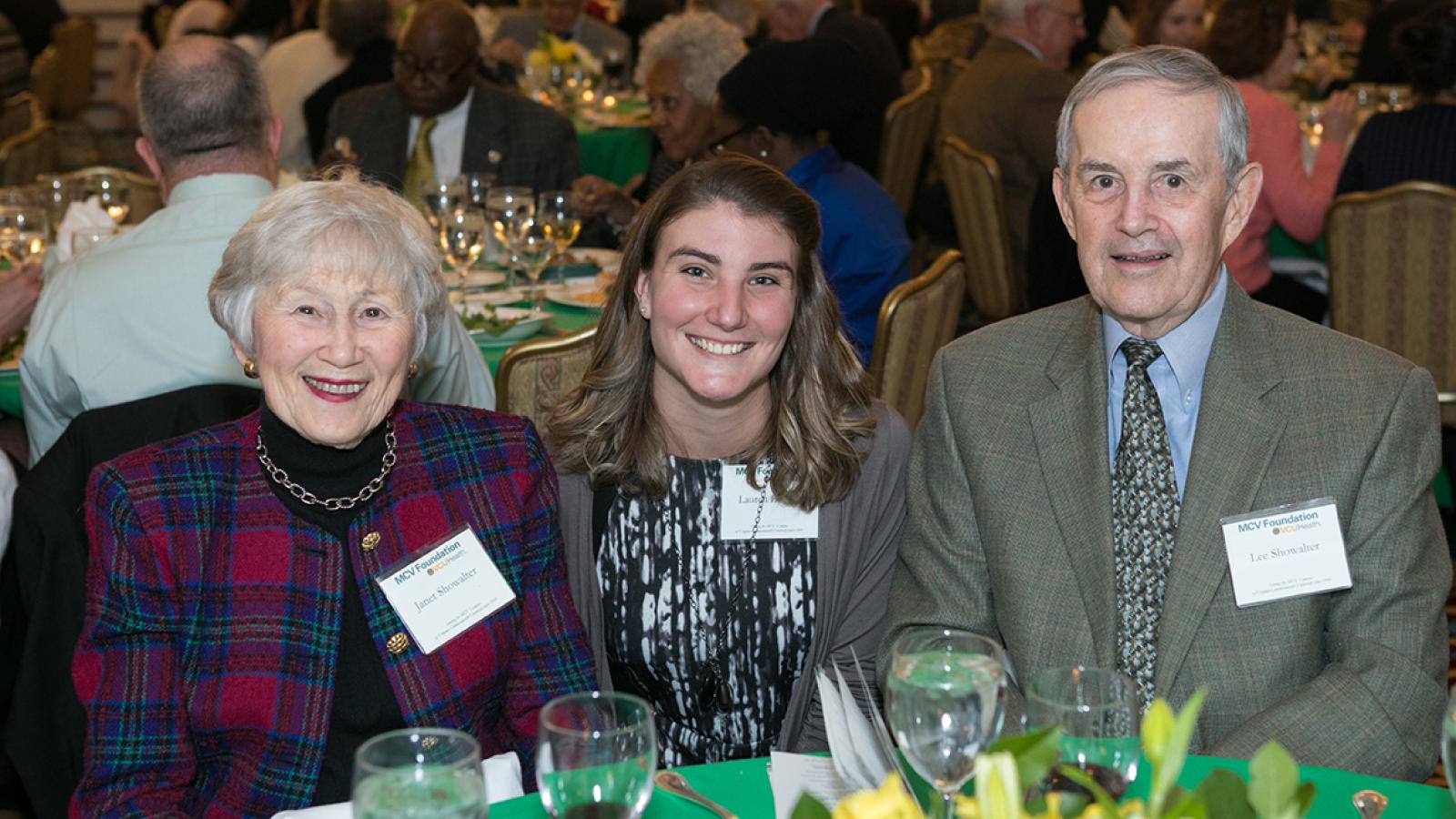 A scholarship recipient with her benefactors