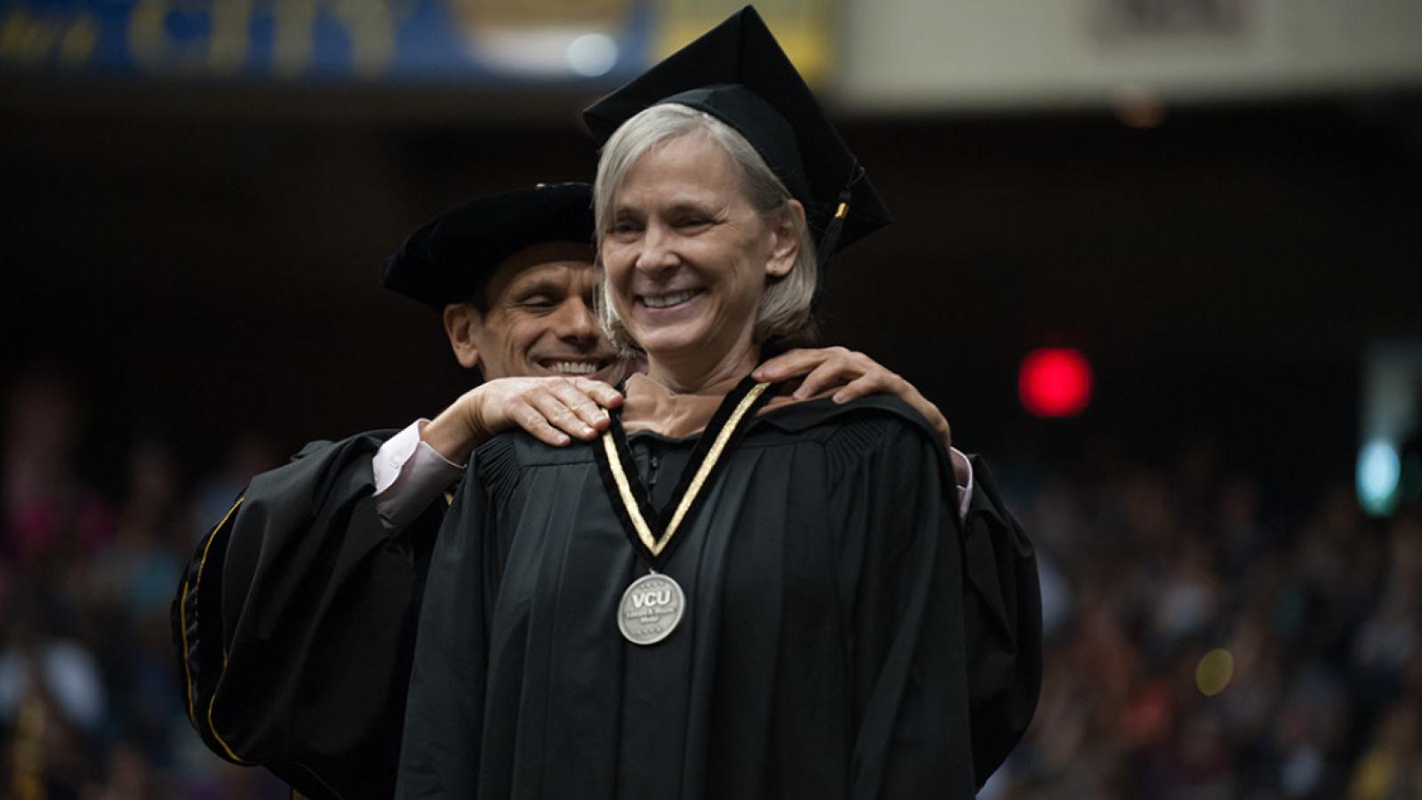 Ginny Crone receives the Edward A. Wayne Medal at VCU's commencement on May 12.