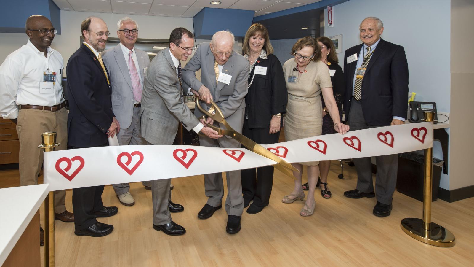 VCU Health leaders and supporters cut the ribbon to the new Cardiac Imaging Suite on July 17. (L to R) Vigneshwar Kasirajan, M.D., chair of the Department of Surgery; Ken Ellenbogen, M.D., chair of the Division of Cardiology; Peter Buckley, M.D., dean of the School of Medicine; William Hundley, M.D., director of the Pauley Heart Center; Stan Pauley; Kathy Pauley Hickok; Marsha Rappley, M.D., vice president for health sciences and CEO of the VCU Health System; Deborah Davis, CEO of VCU Health System Hospital