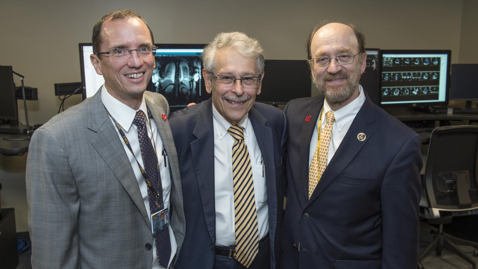 William Hundley, M.D., director of the Pauley Heart Center, spends time with George Vetrovec, M.D., former chair of the Division of Cardiology, and Ken Ellenbogen, M.D., current chair of the Division of Cardiology, after the ribbon cutting at VCU Health’s new Cardiac Imaging Suite. Photo: Kevin Morley, VCU University Marketing