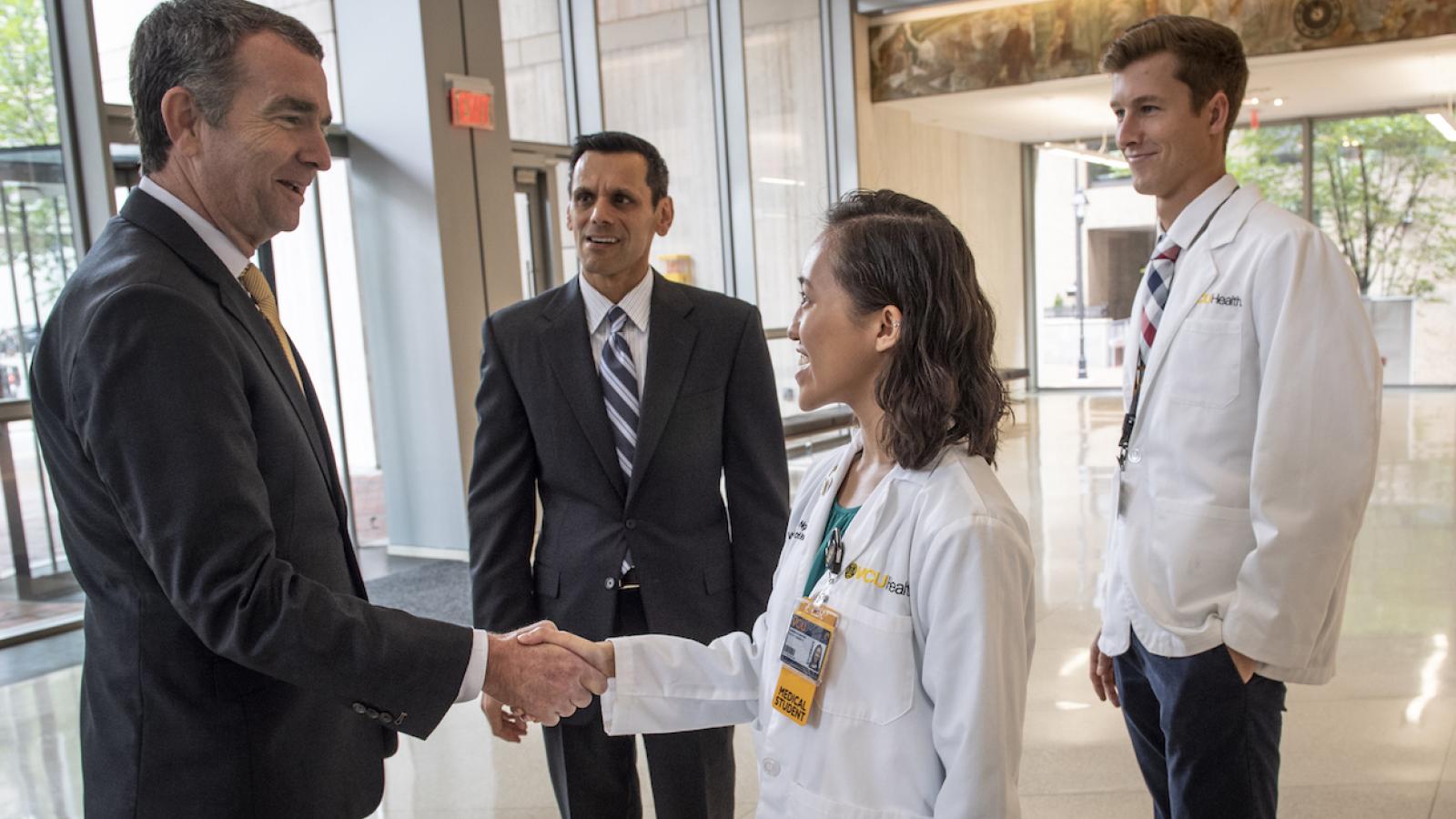 Gov. Ralph Northam and VCU President Michael Rao, Ph.D., meet with School of Medicine students. Photo: Allen Jones, VCU University Marketing