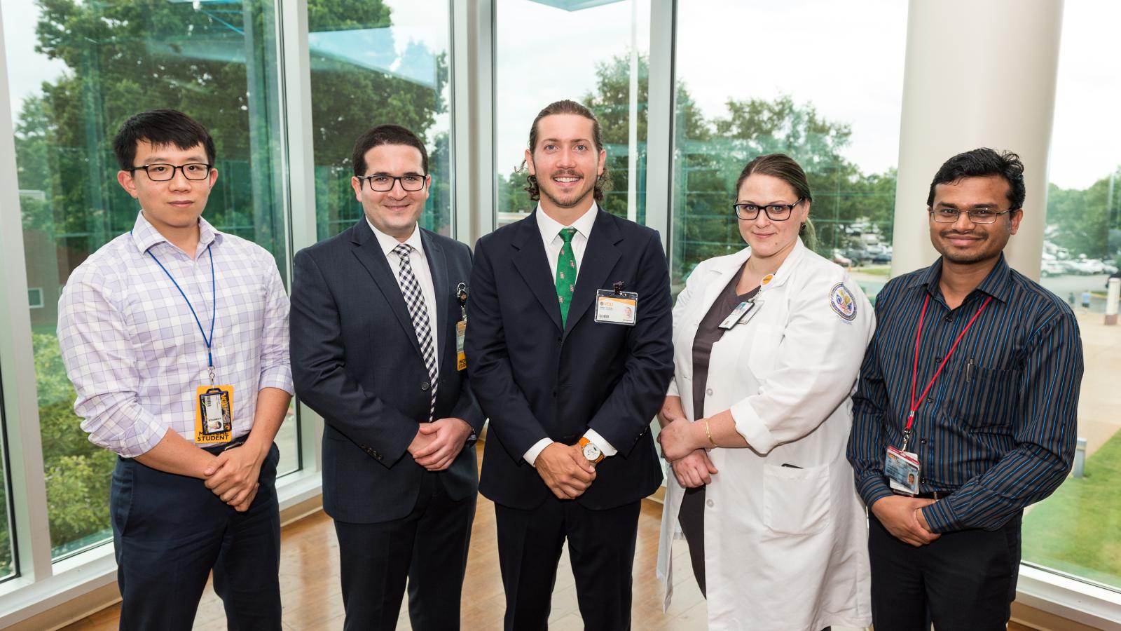 Dr. Holloway’s team includes (L to R) VCU School of Medicine students Zi Huang, Adel Azghadi and Evan Hughes, intraoperative monitoring technologist Rachel Van Aken, and post-doctoral trainee Deepak Kumbhare, Ph.D. The team is conducting research into techniques and possibilities of how deep brain stimulation can treat dementia. Photo: Kevin Schindler
