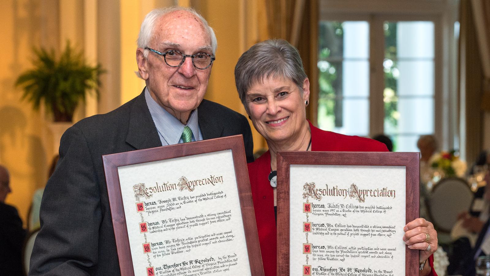 Joe Teefey, who served nine years on the MCV Foundation Board of Trustees, and Judy Collins, who served 21 years, review the resolutions welcoming them as the board’s newest Lifetime Honorary Trustees.