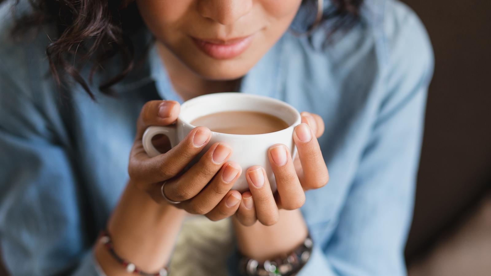 Woman Smelling Coffee