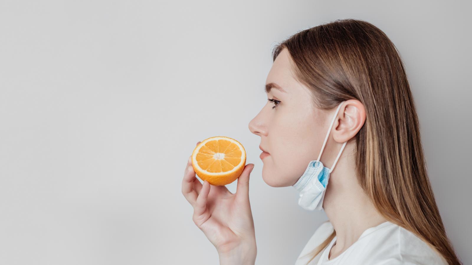 Woman Smelling Orange